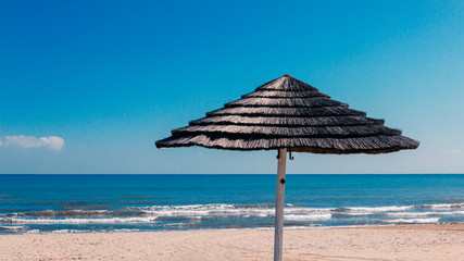 reed beach umbrellas on a deserted beach