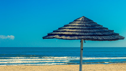 reed beach umbrellas on a deserted beach