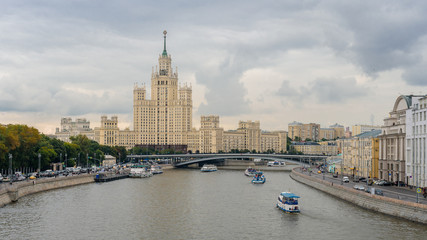 Fototapeta na wymiar MOSCOW, RUSSIA - July 12, 2019. Cityscape with Moscow-river and famous Stalin's skyscraper on Kotelnicheskaya embankment.
