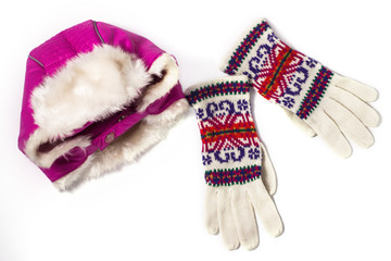 Fototapeta na wymiar Winter flatlay, warm pink hat with earflaps and woolen knitted gloves on a white background. Top view, mockup.