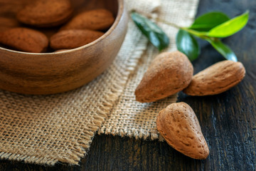 Some almonds on the wooden table. Healthy food concept.