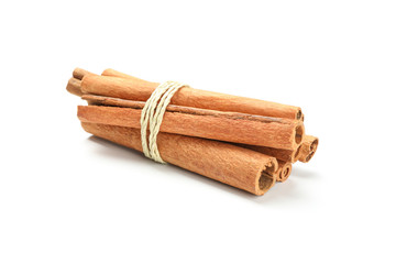 Tied cinnamon sticks isolated on white background. Sweet spice