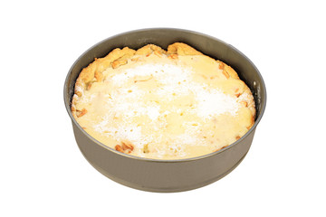 Apple pie with sour cream filling in a metal baking dish isolated on a white background