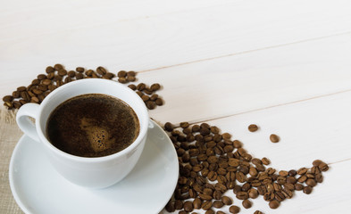 coffee cup and coffee beans on wooden table