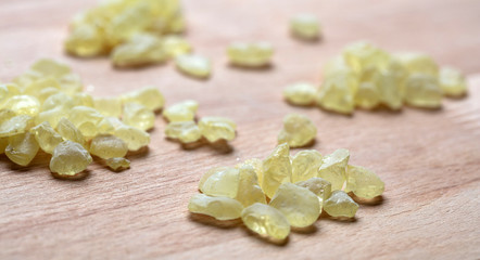 Chios mastic tears on wood, closeup view