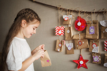 advent calendar hanging on the wall. child opens present. Christmas kids fun. handmade