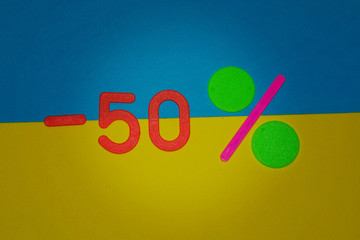 Plate minus 50 percent on yellow and blue background . Winter Merry Christmas, New year sale. 50 off discount promotion sale poster, banner, ads in store, shop, drugstore, market window.
