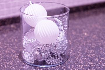 White color vase with christmas decor composition of pine branches, and toy balls.Christmas home decorations. silver balls, DIY idea for interior design.New Year mood.Minimal, flat lay, copy space.