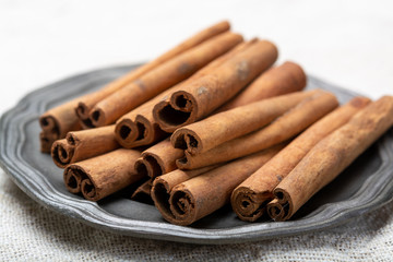 Winter food ingredient, dried aromatic cinnamon sticks on tin plate