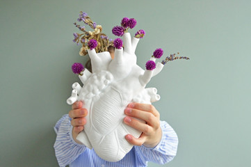 Heart shaped porcelain vase held by girl