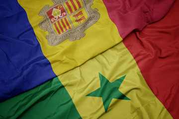waving colorful flag of senegal and national flag of andorra.