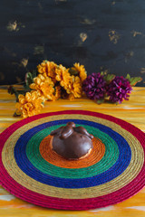 Pan de Muerto, Bread of Dead Mexican Sugar Scone and Chocolate on Woven Tablecloth.