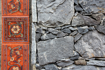 stone wall with a border of tiles with a look
