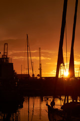 Fototapeta na wymiar Sunset in the port. Photo with masts on the sunset. Ensenada. Baja California. Mexico.