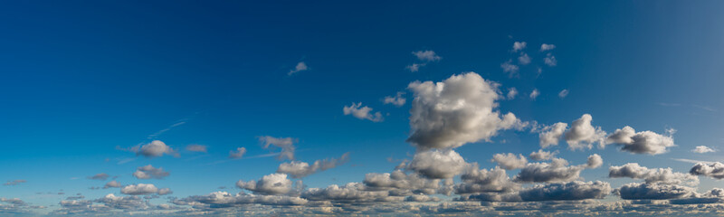 Fantastic clouds against blue sky, panorama