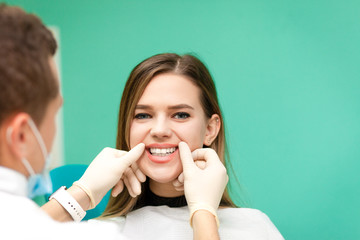 Young girl at the dentist's appointment. Dentist checks a girl’s teeth