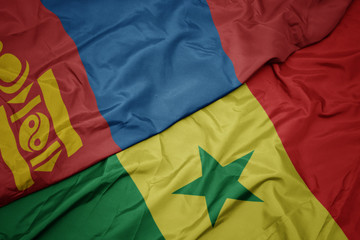 waving colorful flag of senegal and national flag of mongolia.