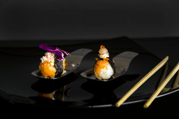 Two gourmet nigiri on beautiful plates