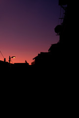 Purple sunset in little Italian mountain town. Visible building countures and beautiful sunset color.