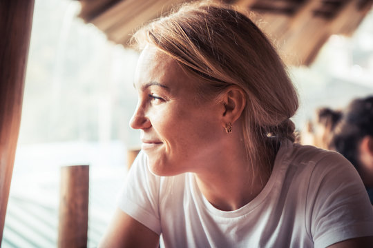 Happy beautiful smiling woman portrait with natural light on woman face with authentic smile 