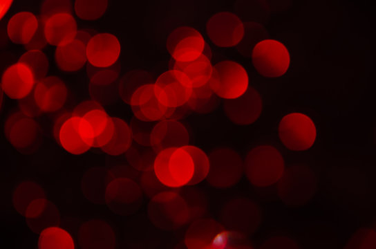 Abstract pattern of red bokeh garland lights on a dark background