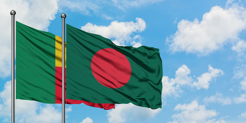 Benin and Bangladesh flag waving in the wind against white cloudy blue sky together. Diplomacy concept, international relations.