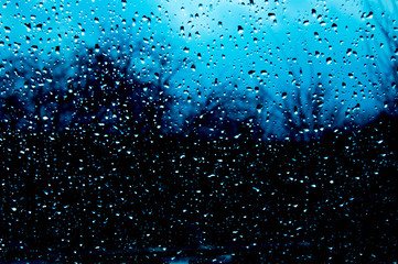 Beautiful sky and clouds, rain, wet glass, drops of water on the glass, drops of water on the window, drops