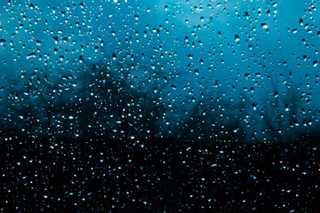 Beautiful sky and clouds, rain, wet glass, drops of water on the glass, drops of water on the window, drops