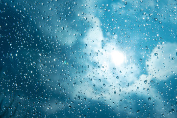 Naklejka na ściany i meble Beautiful sky and clouds, rain, wet glass, drops of water on the glass, drops of water on the window, drops