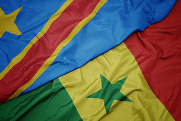 waving colorful flag of senegal and national flag of democratic republic of the congo.