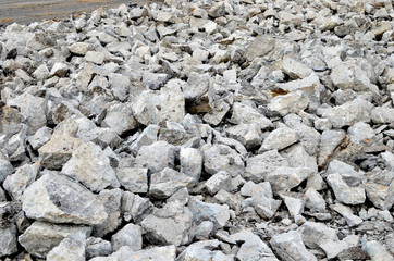 Recycling and reuse crushed concrete rubble, asphalt, building material, blocks. Broken concrete slabs at construction site. Сoncrete rubble from demolition at landfill. Hardcore waste recycling