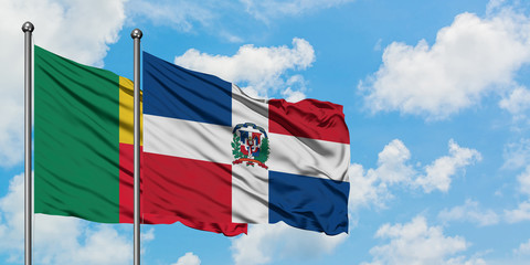 Benin and Dominican Republic flag waving in the wind against white cloudy blue sky together. Diplomacy concept, international relations.