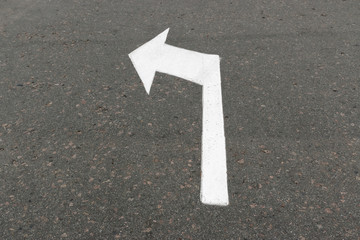 Road marking on asphalt with direction of movement