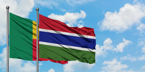 Benin and Gambia flag waving in the wind against white cloudy blue sky together. Diplomacy concept, international relations.