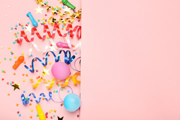 Colorful ribbons with rubber balloons and sprinkles on pink background