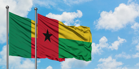 Benin and Guinea Bissau flag waving in the wind against white cloudy blue sky together. Diplomacy concept, international relations.