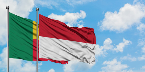 Benin and Indonesia flag waving in the wind against white cloudy blue sky together. Diplomacy concept, international relations.