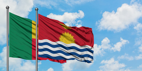 Benin and Kiribati flag waving in the wind against white cloudy blue sky together. Diplomacy concept, international relations.