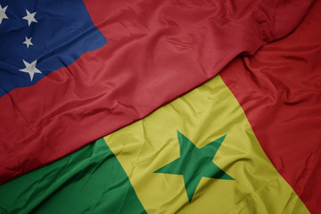 waving colorful flag of senegal and national flag of Samoa .