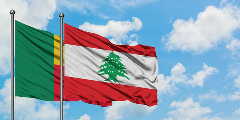 Benin and Lebanon flag waving in the wind against white cloudy blue sky together. Diplomacy concept, international relations.