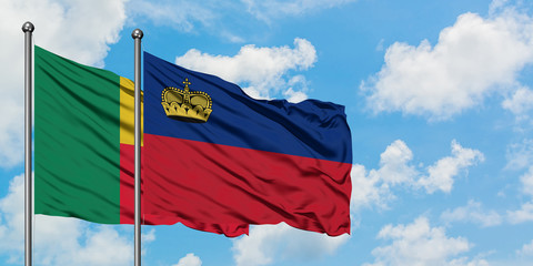 Benin and Liechtenstein flag waving in the wind against white cloudy blue sky together. Diplomacy concept, international relations.