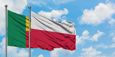 Benin and Poland flag waving in the wind against white cloudy blue sky together. Diplomacy concept, international relations.
