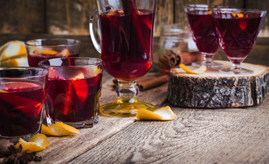 Christmas mulled wine with spices and oranges on wooden table, hot drinks