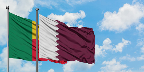 Benin and Qatar flag waving in the wind against white cloudy blue sky together. Diplomacy concept, international relations.