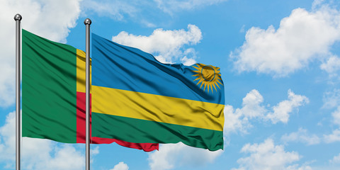 Benin and Rwanda flag waving in the wind against white cloudy blue sky together. Diplomacy concept,...