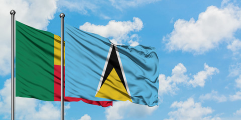 Benin and Saint Lucia flag waving in the wind against white cloudy blue sky together. Diplomacy concept, international relations.