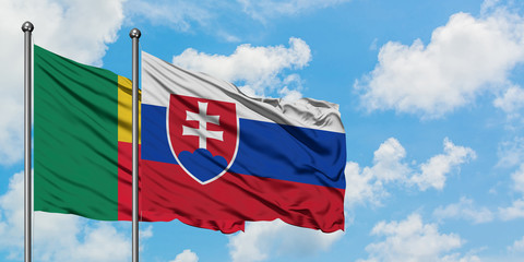 Benin and Slovakia flag waving in the wind against white cloudy blue sky together. Diplomacy concept, international relations.