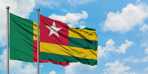 Benin and Togo flag waving in the wind against white cloudy blue sky together. Diplomacy concept, international relations.