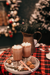Christmas table decor with cocoa and marshmallows.