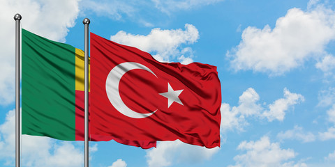 Benin and Turkey flag waving in the wind against white cloudy blue sky together. Diplomacy concept, international relations.